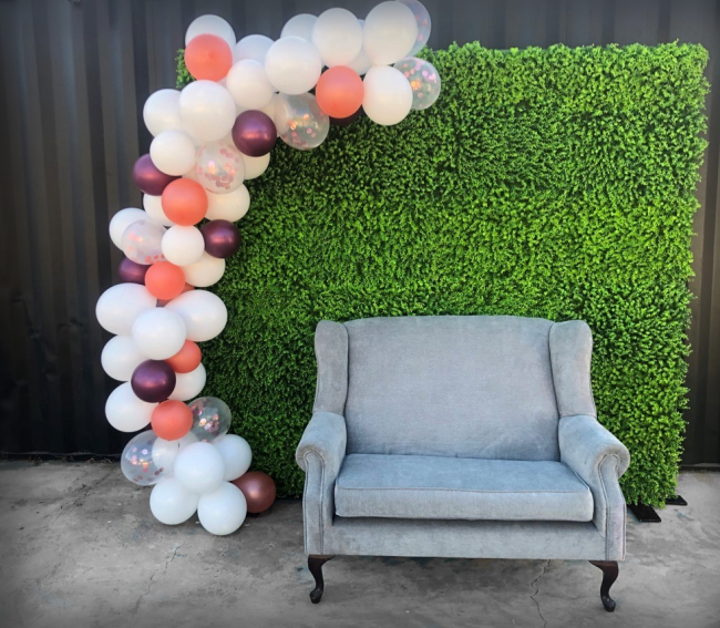 hedge-wall-with-balloons-and-couch